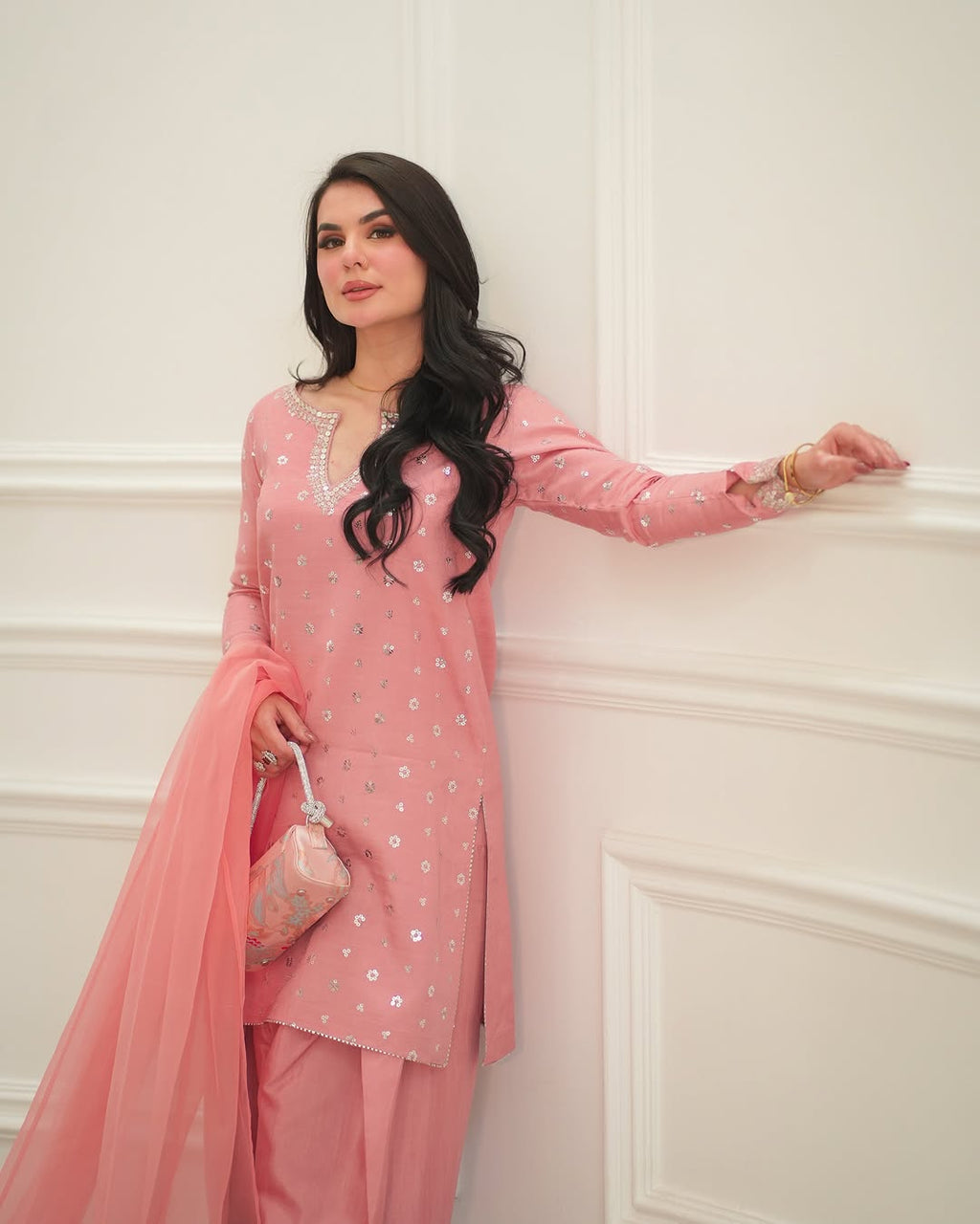 Embrose elegant outfit with embellished neckline and trousers.