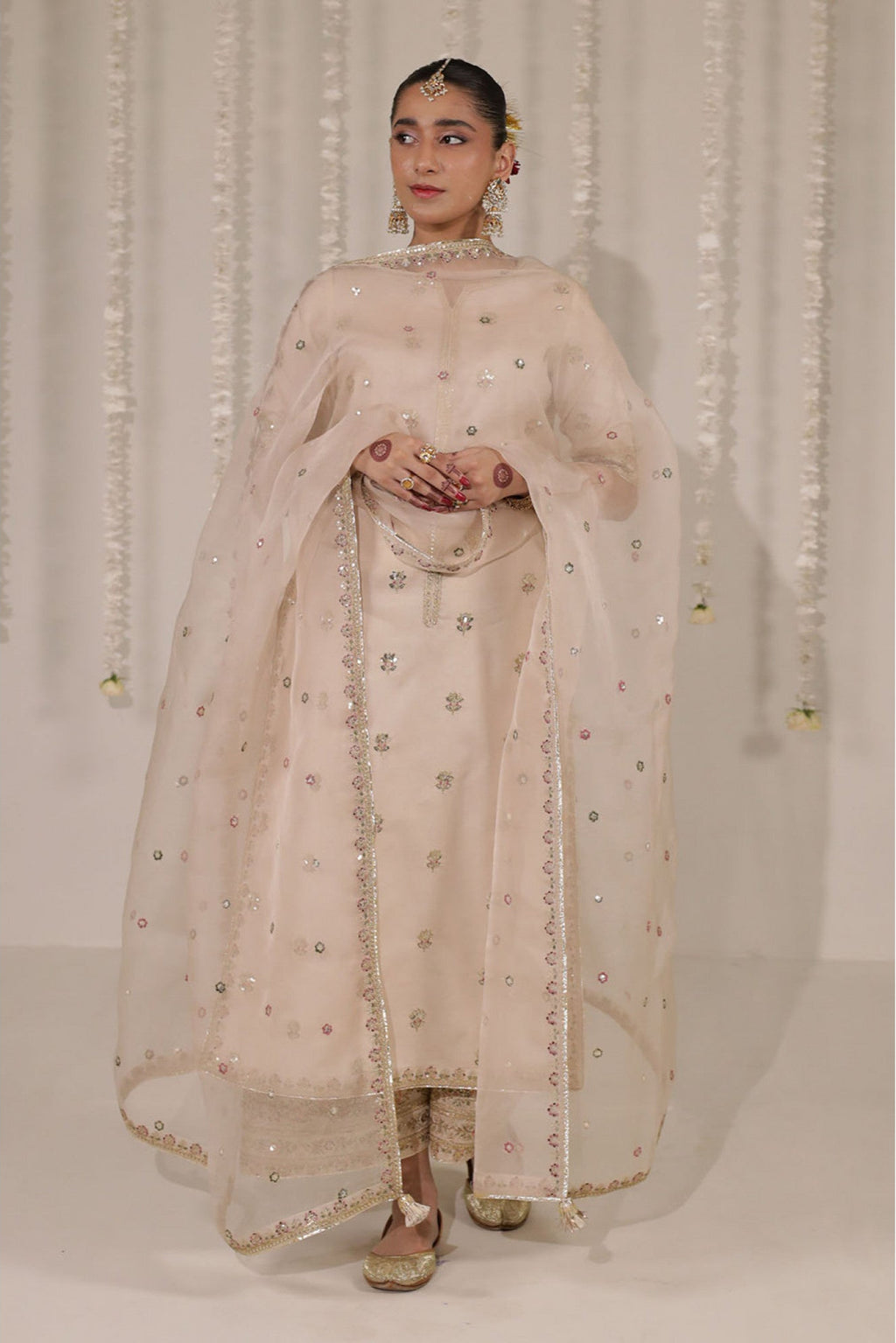 Zarnoor elegant champagne suit with glistening mirror-style embroidery.